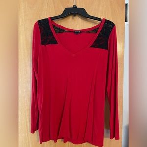 Red sweater with black lace detailing.